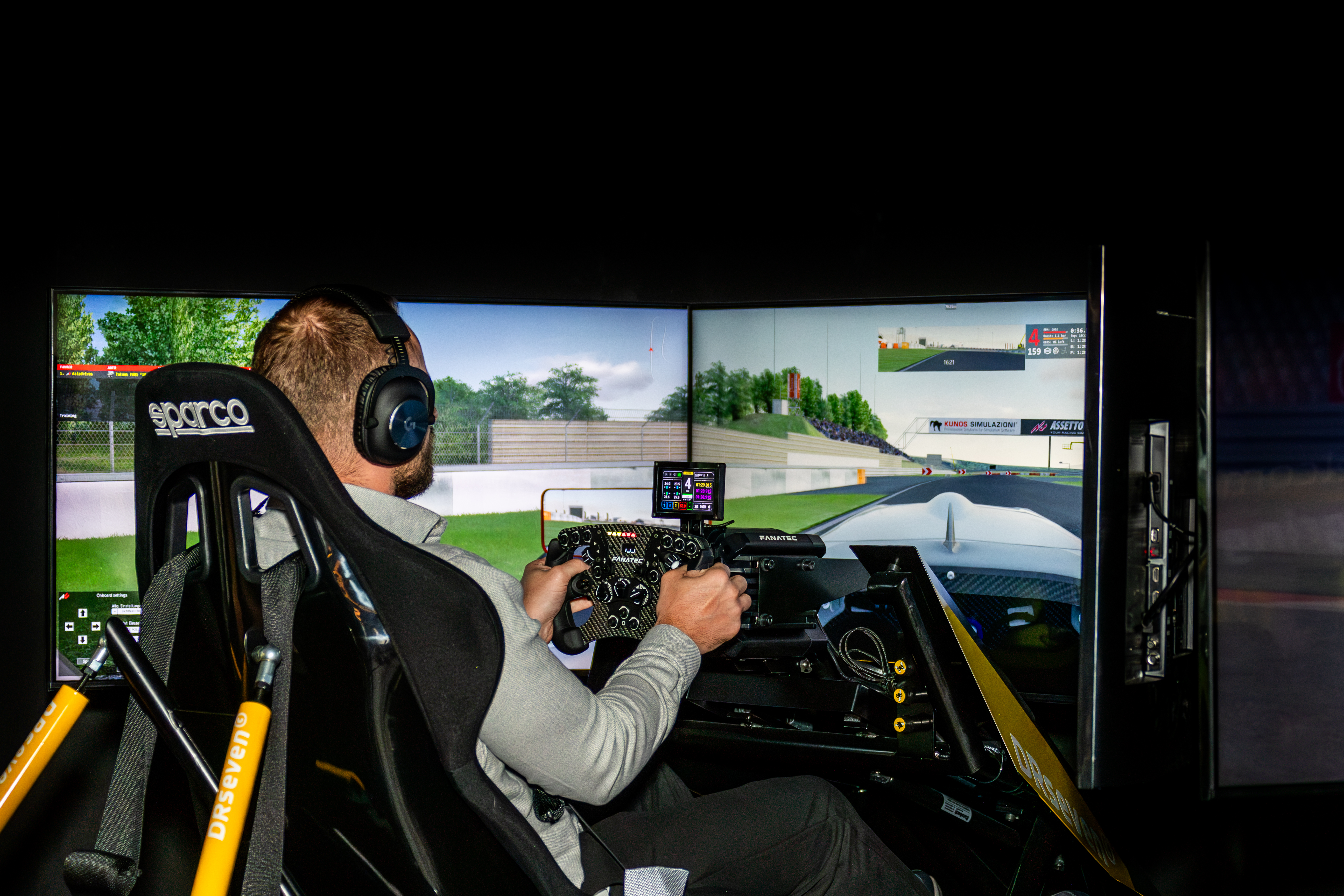 a guy enjoying a sim racing simulator at Nürburgring eSports